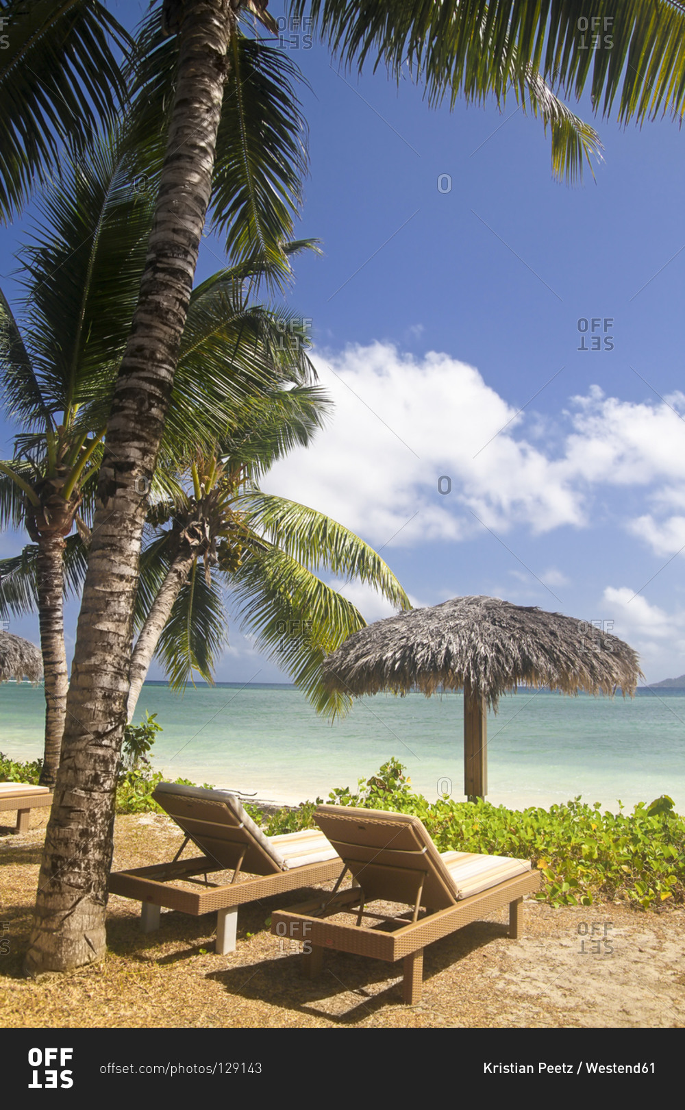 La Digue Island View of the beach Anse La Reunion and sun loungers, Seychelles