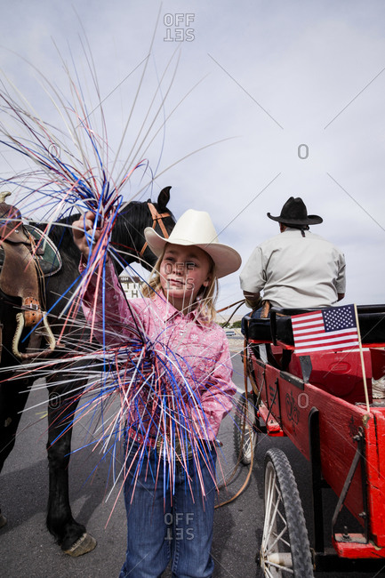 New Mexico, USA - May 11, 2013: Girl playing with colorful pom-poms during a parade in Truth or Consequences, New Mexico, USA