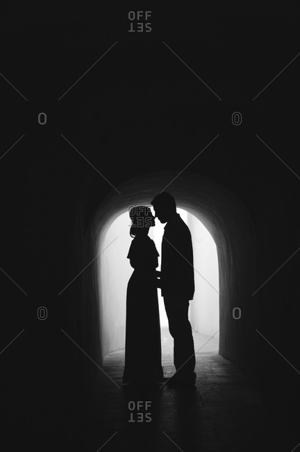 Couple nuzzling in tunnel