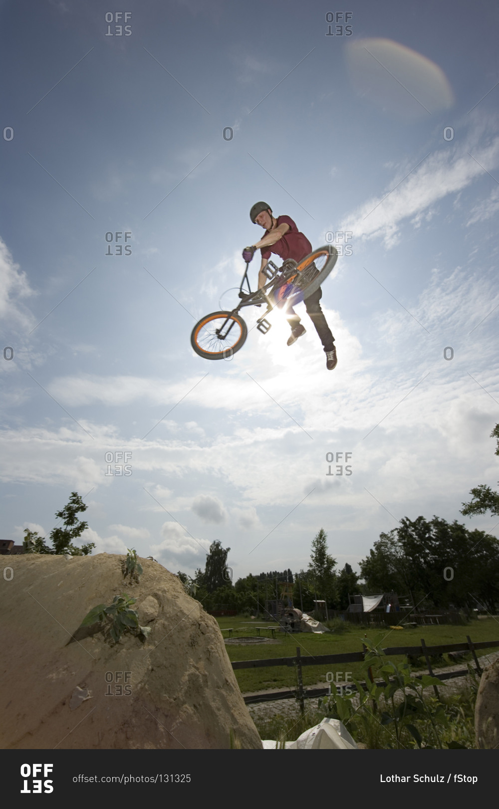 A BMX rider doing a stunt in mid-air