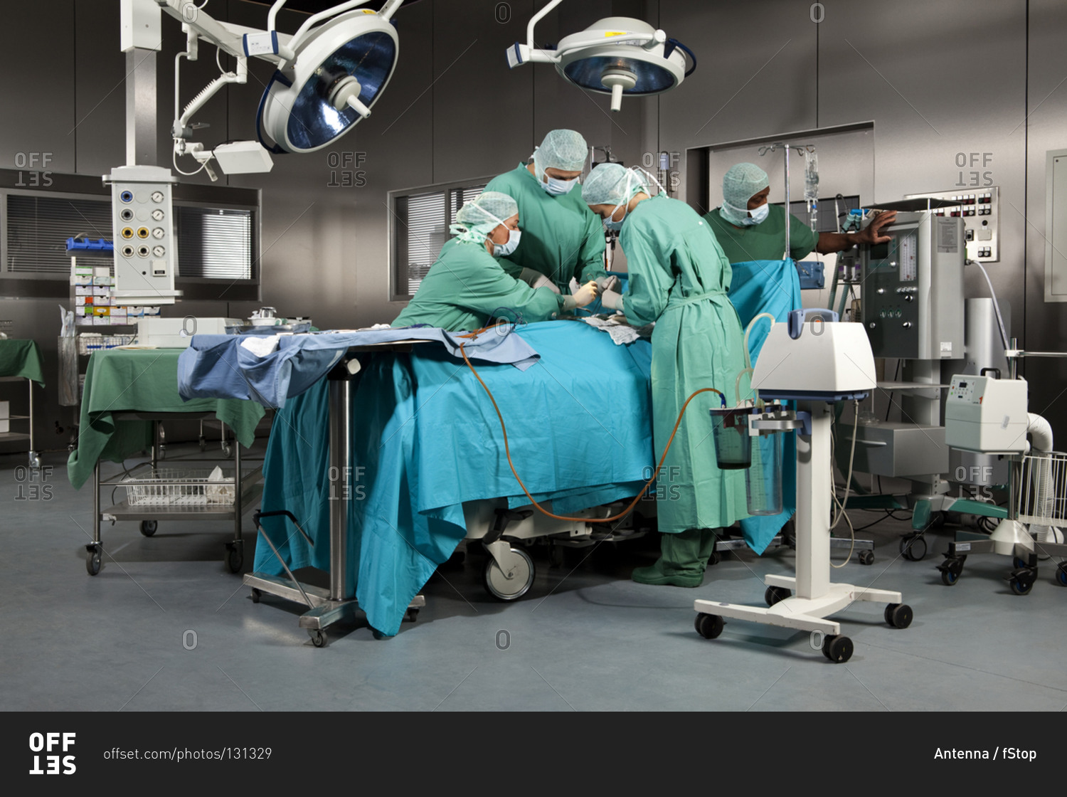 Doctors and nurses operating on a patient in a operating room