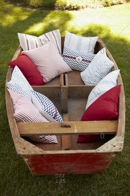 Boat with colorful cushions in a garden