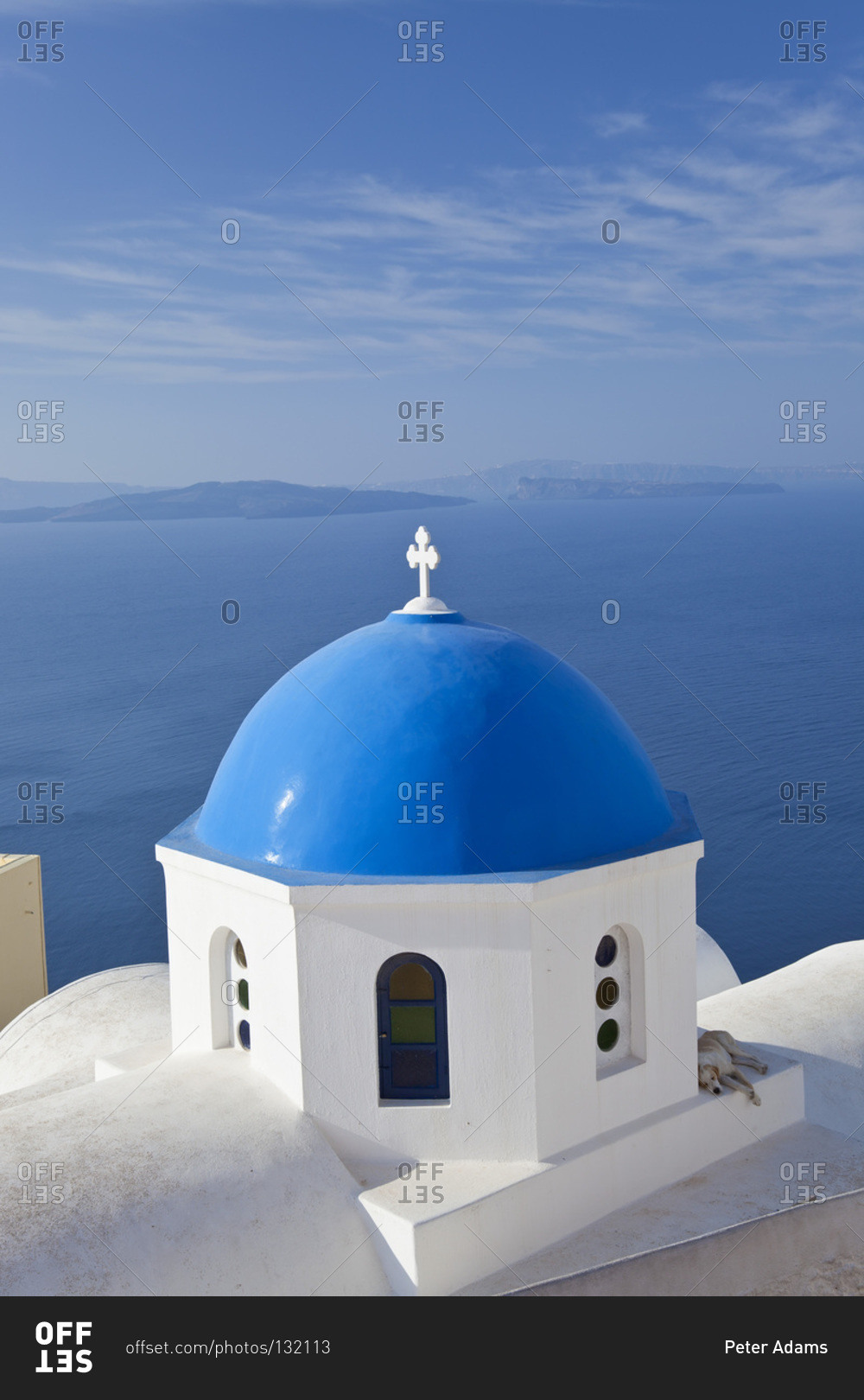 Church dome with sleeping dog, Oia, Santorini, Greece