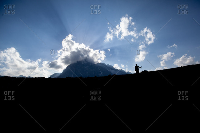 Distant silhouette of a Kashmiri shepherd in the Himalayan mountains, India