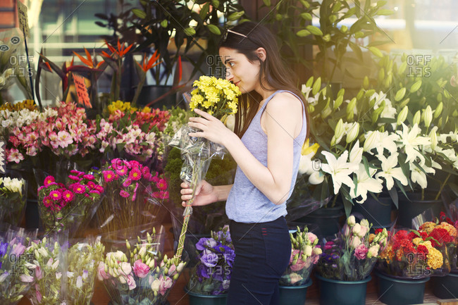 Woman smelling a bouquet of flowers