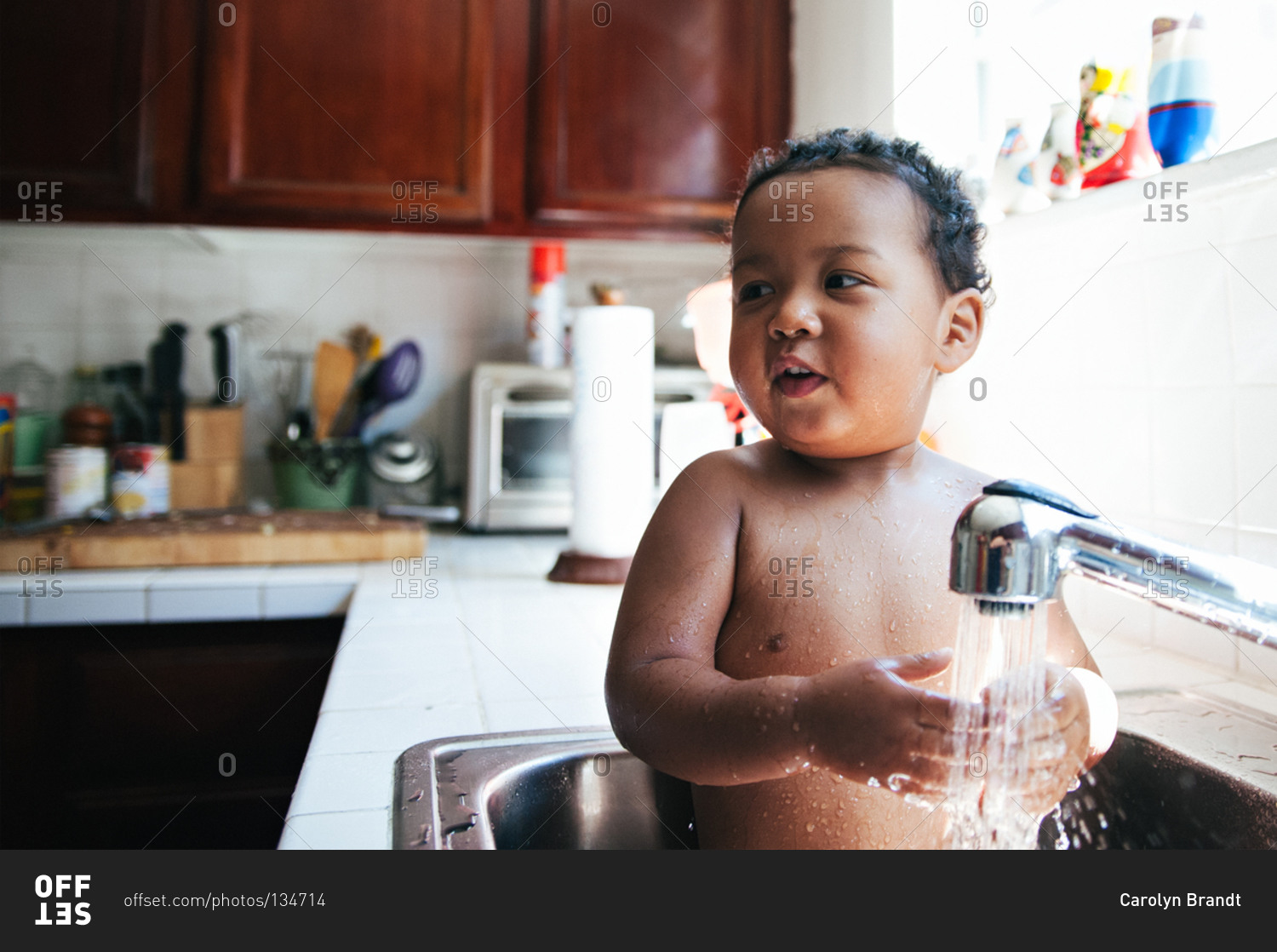 Baby taking bath in sink stock photo OFFSET