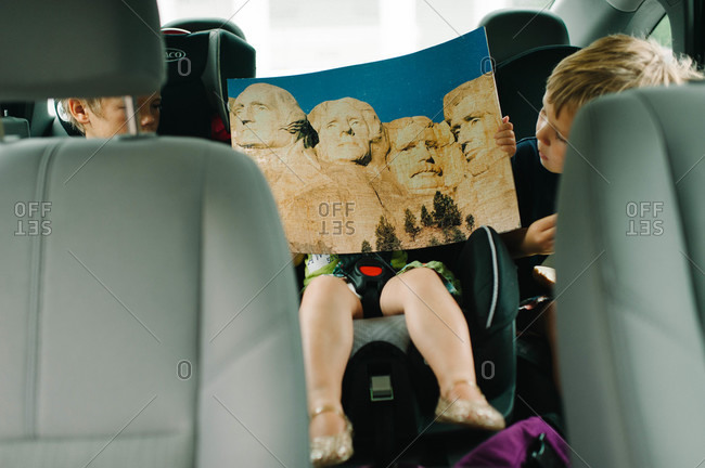 Children watching the brochure of Mount Rushmore National Memorial