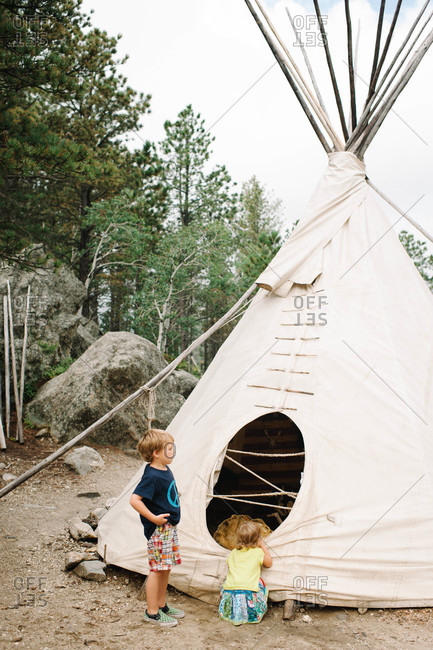 Children looking at a tepee