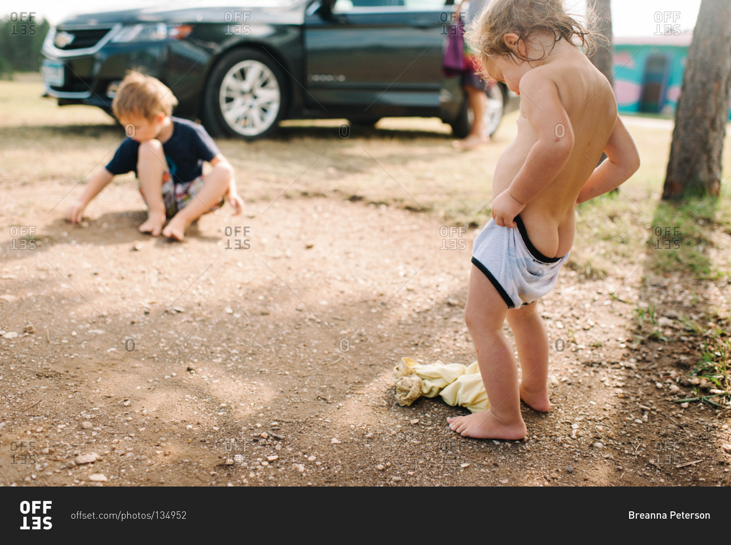 Young girl putting on her underwear stock photo - OFFSET