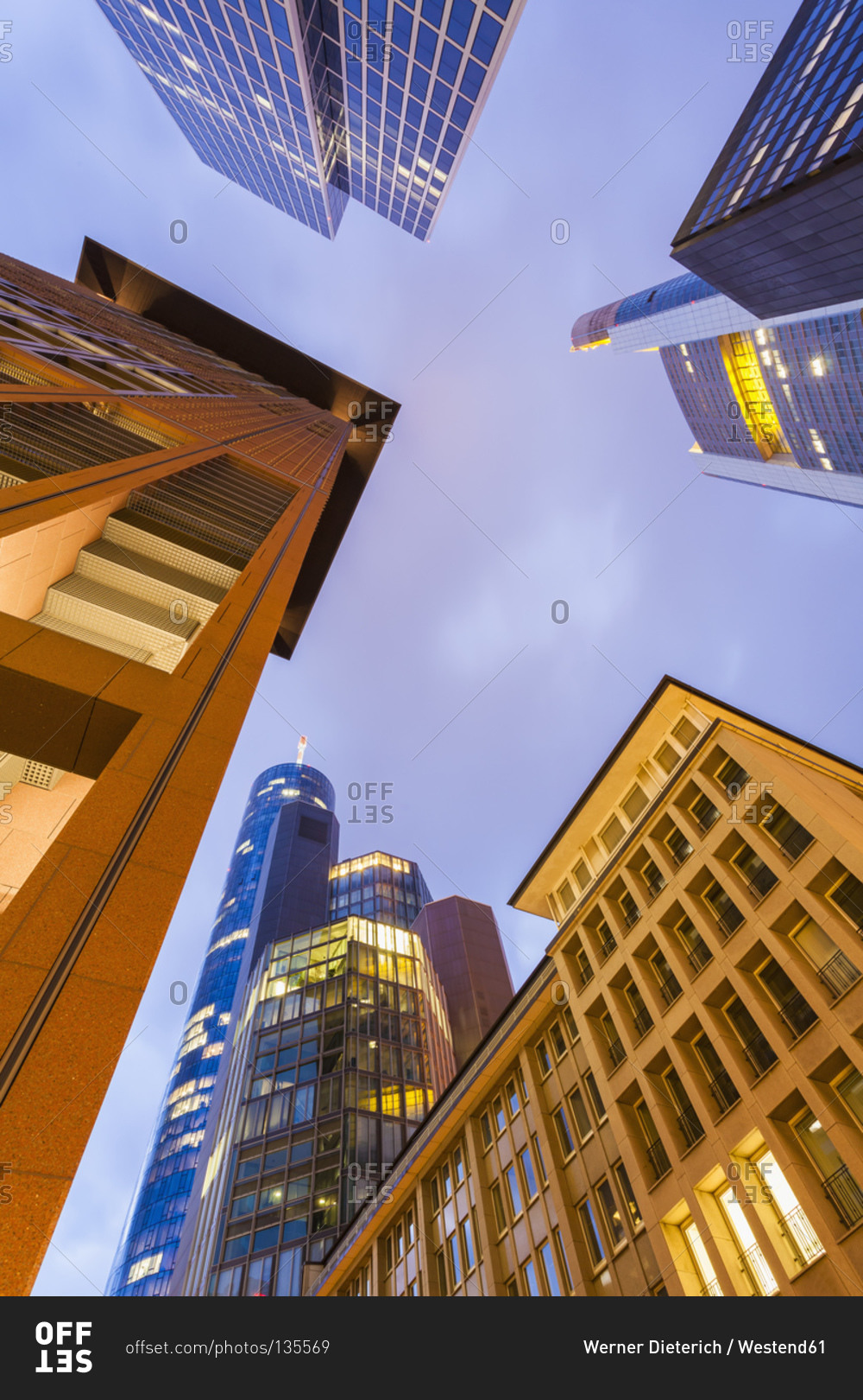 View to facades of modern office buildings from below at twilight
