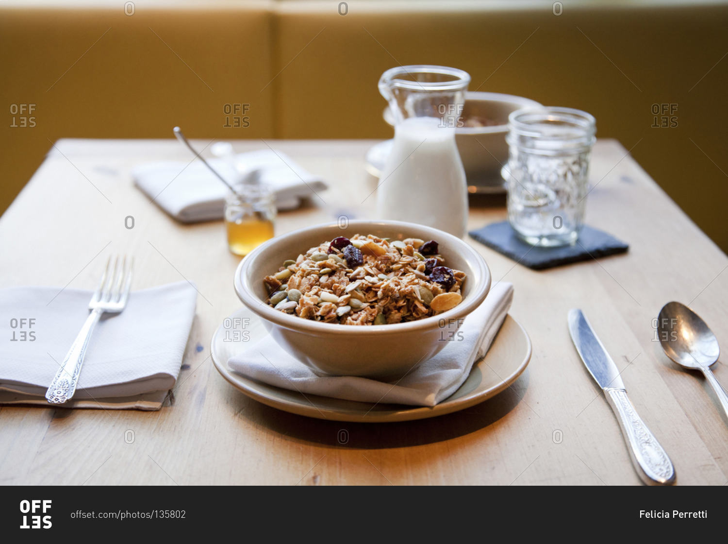 Bowl granola and milk in jug stock photo - OFFSET