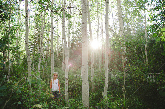 Girl standing among trees - Offset