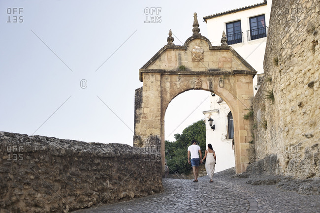 Couple walking along old town wall