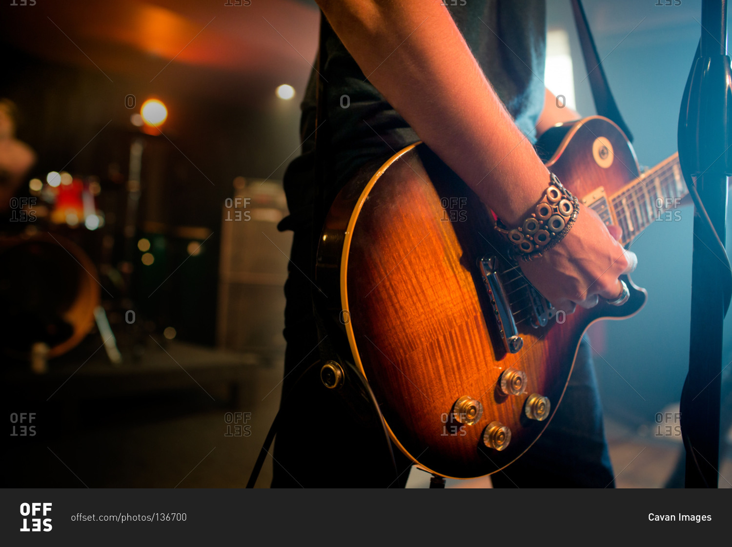 Mid section view of man playing electric guitar stock photo - OFFSET