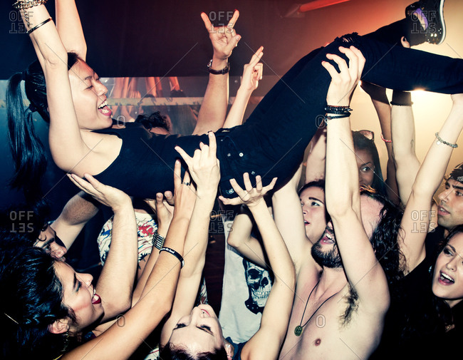 Crowd surfing during a concert