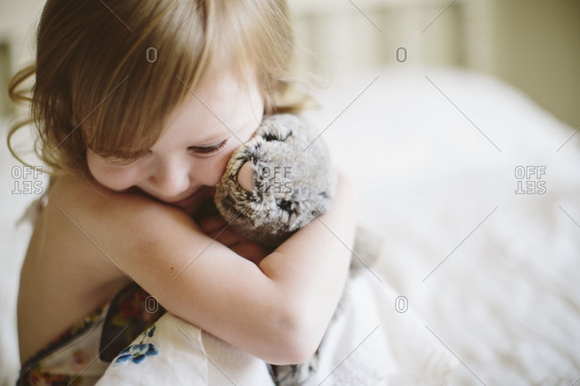 hugging a stuffed animal