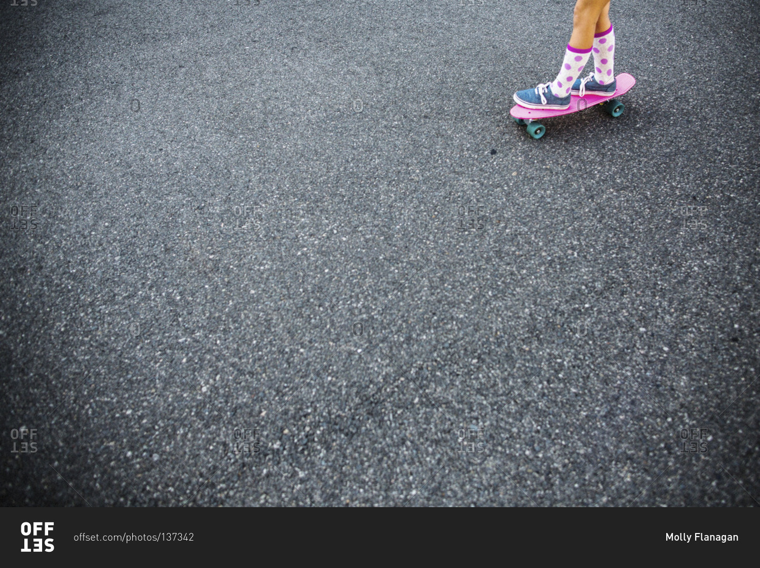 Young girl skateboarding on a street