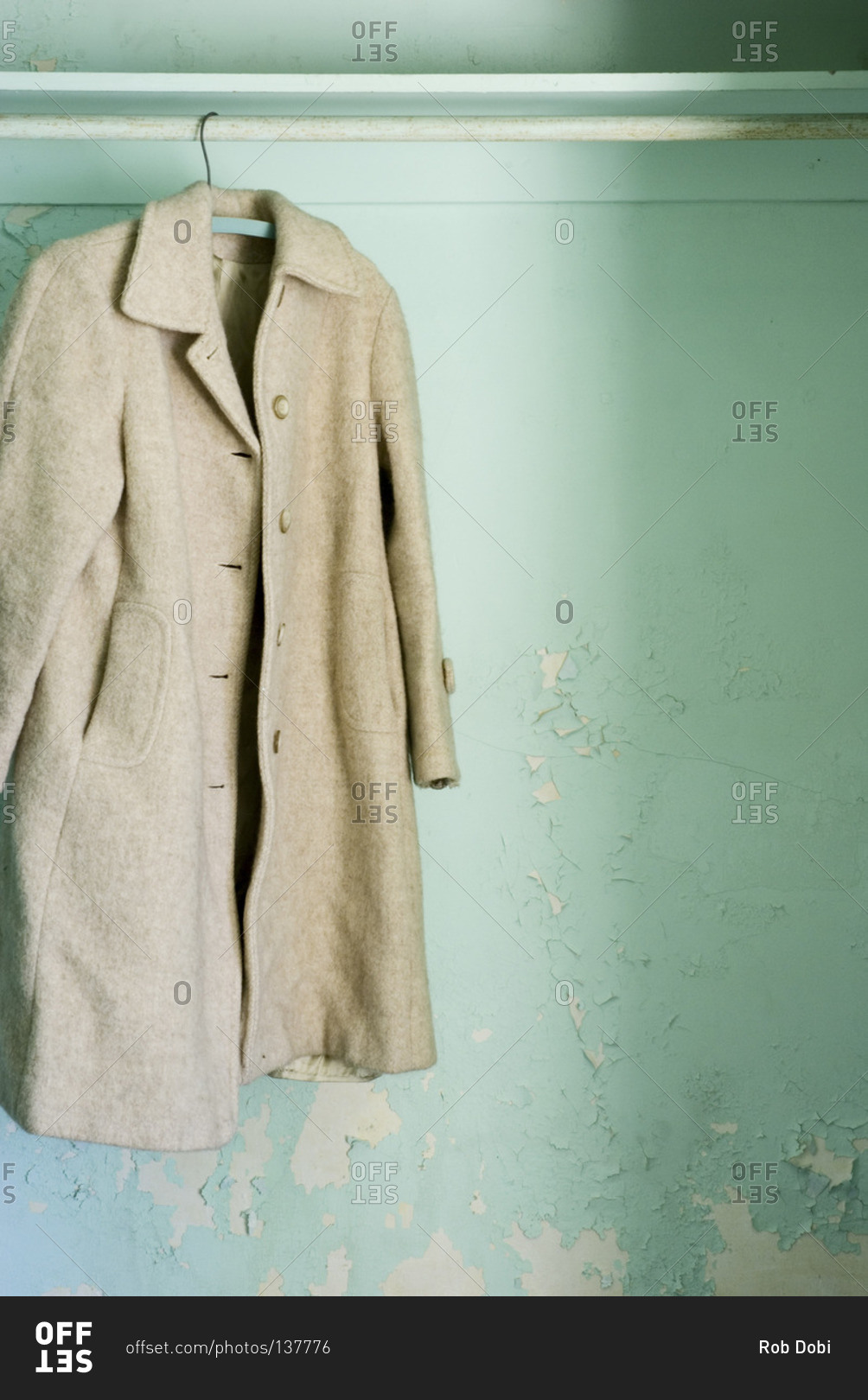 Close up of a coat hanging in a wardrobe stock photo - OFFSET