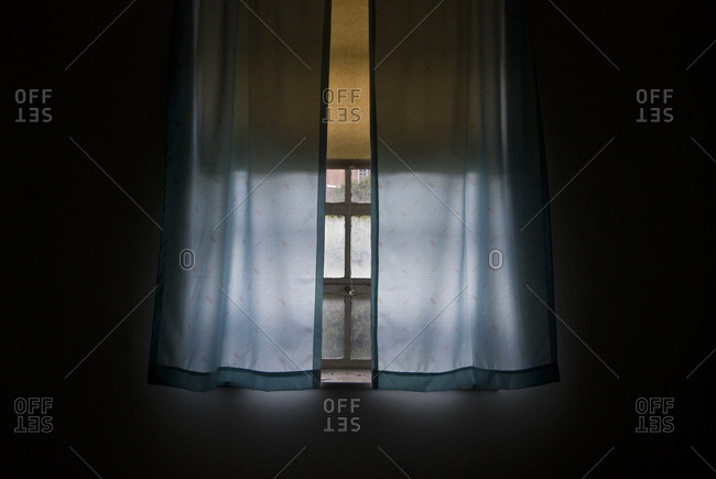 Blue drape and a window in an abandoned room