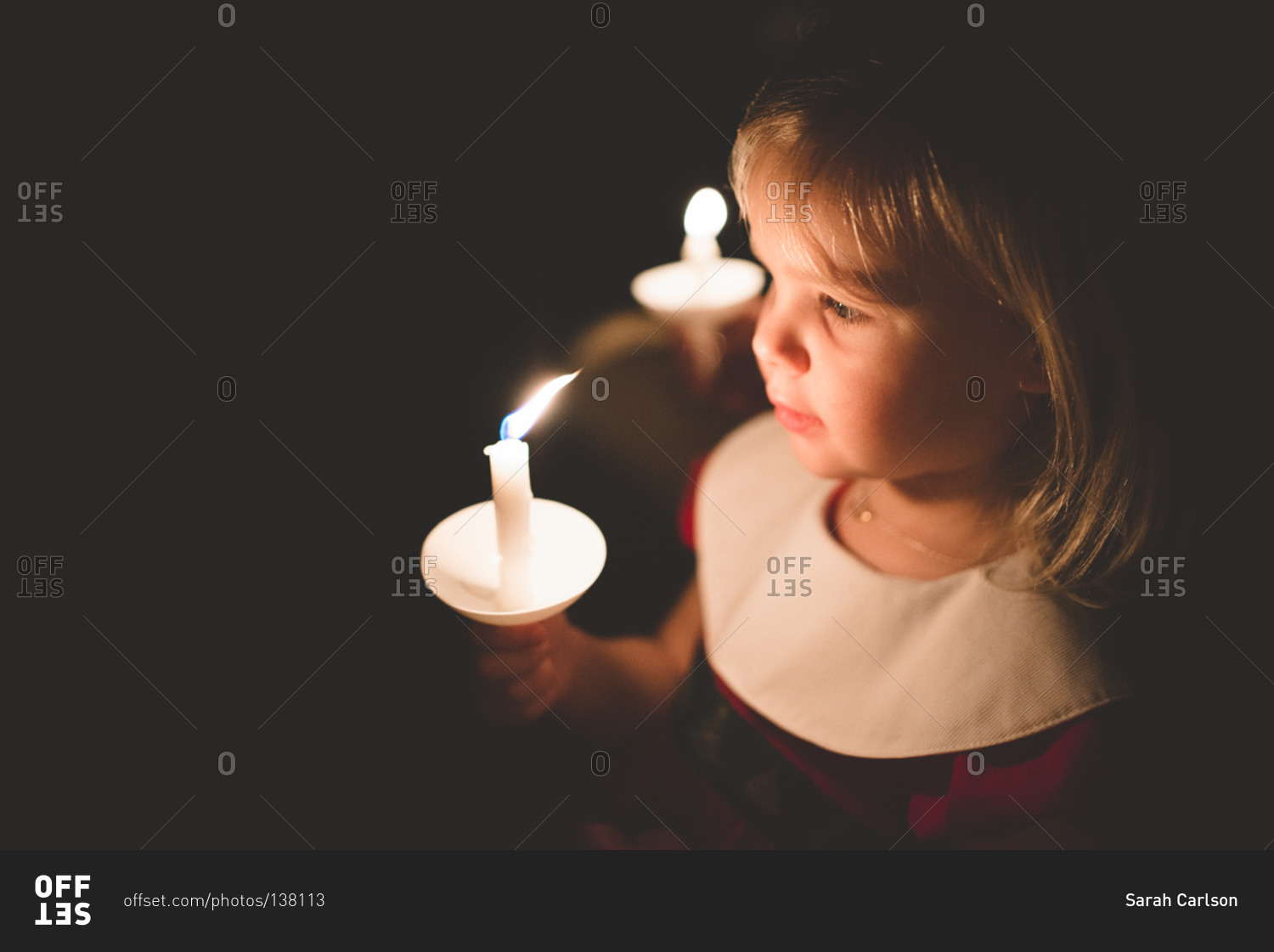 Close up of little girl holding a candle stock photo OFFSET