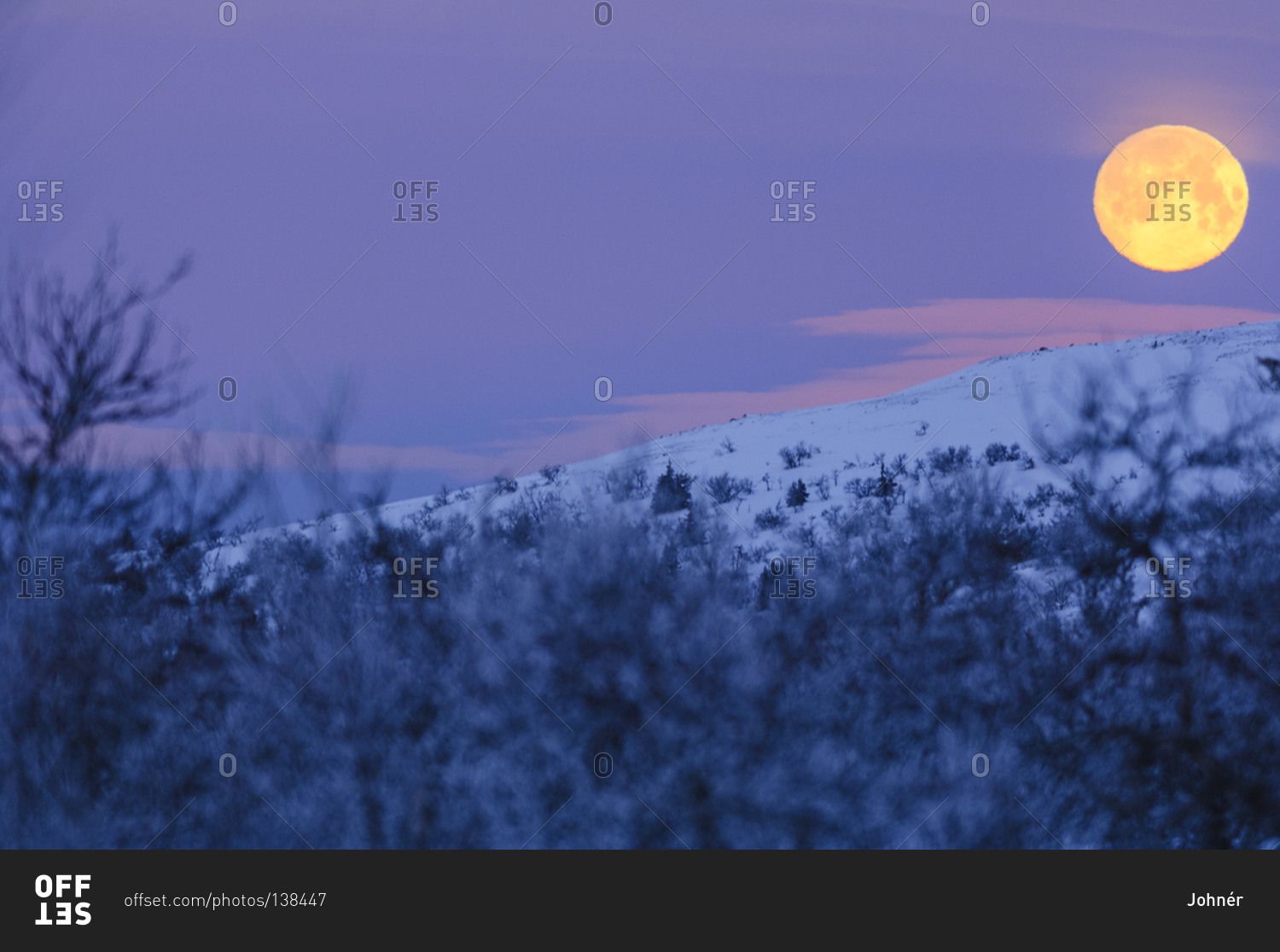 Full moon over winter landscape