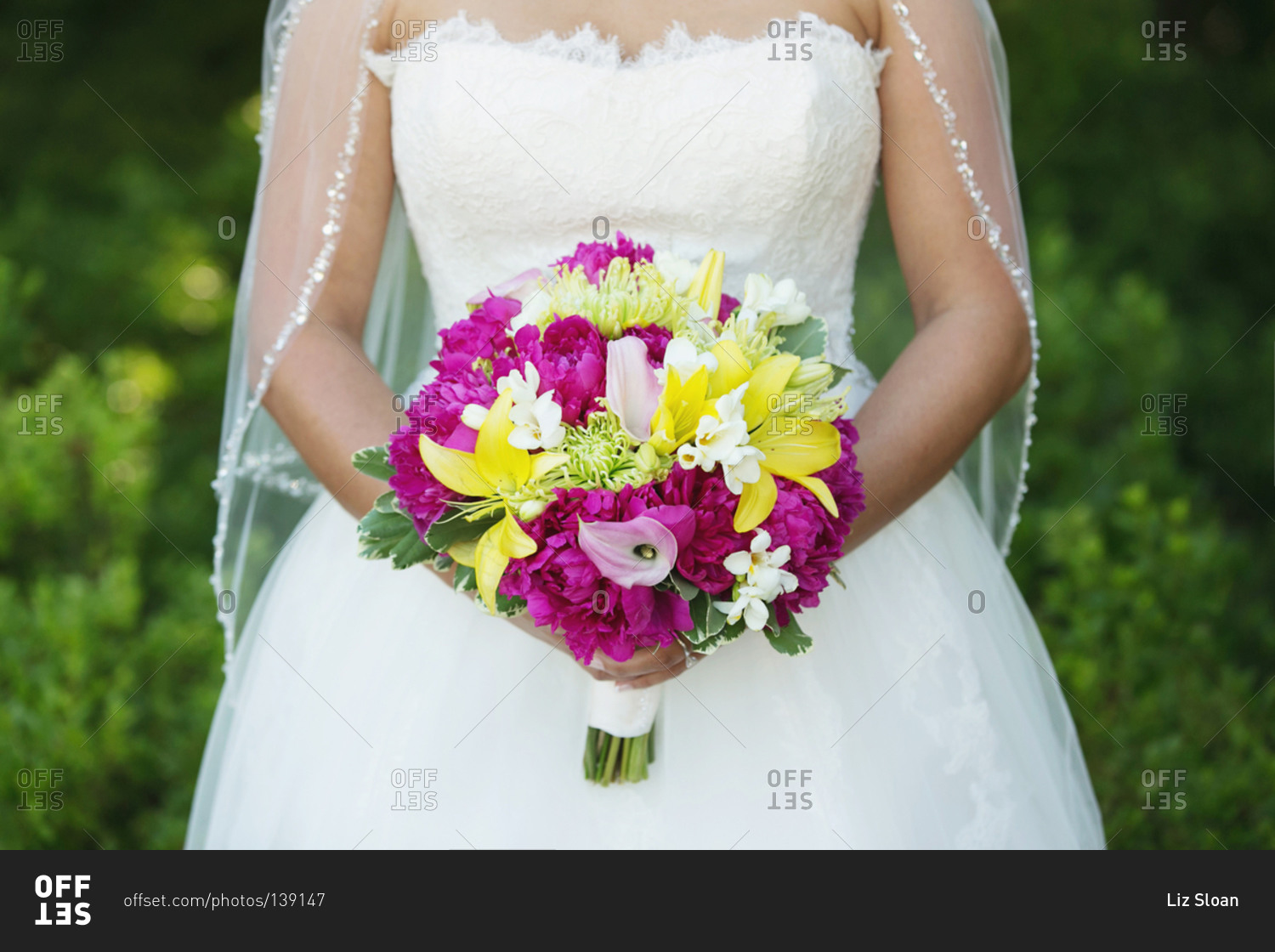 Midsection view of bride holding a bouquet
