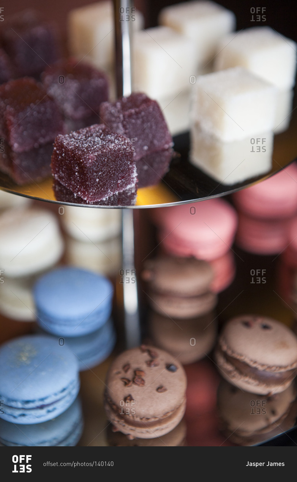 Macarons and jelly cubes on a dessert stand