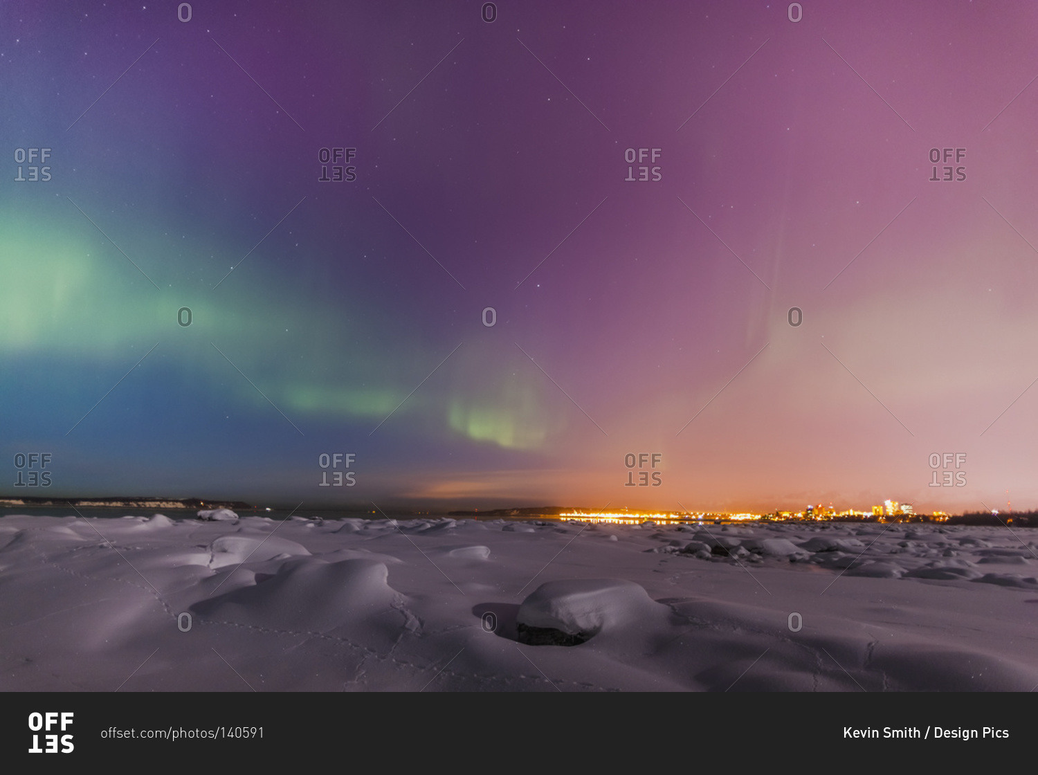 Northern lights shine above city skyline, Anchorage, Alaska