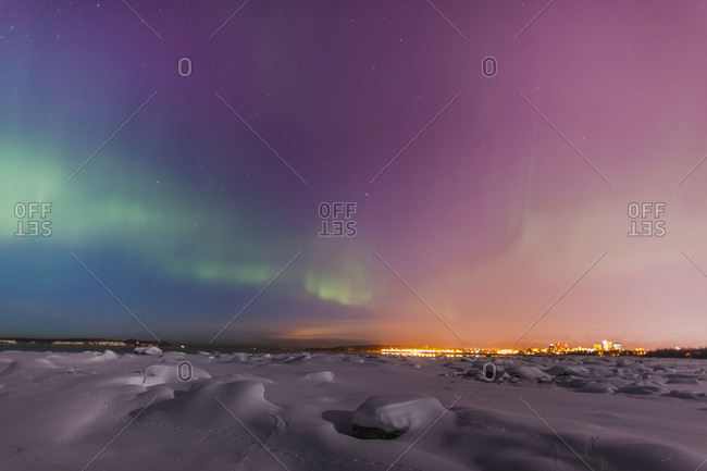 Northern lights shine above city skyline, Anchorage, Alaska
