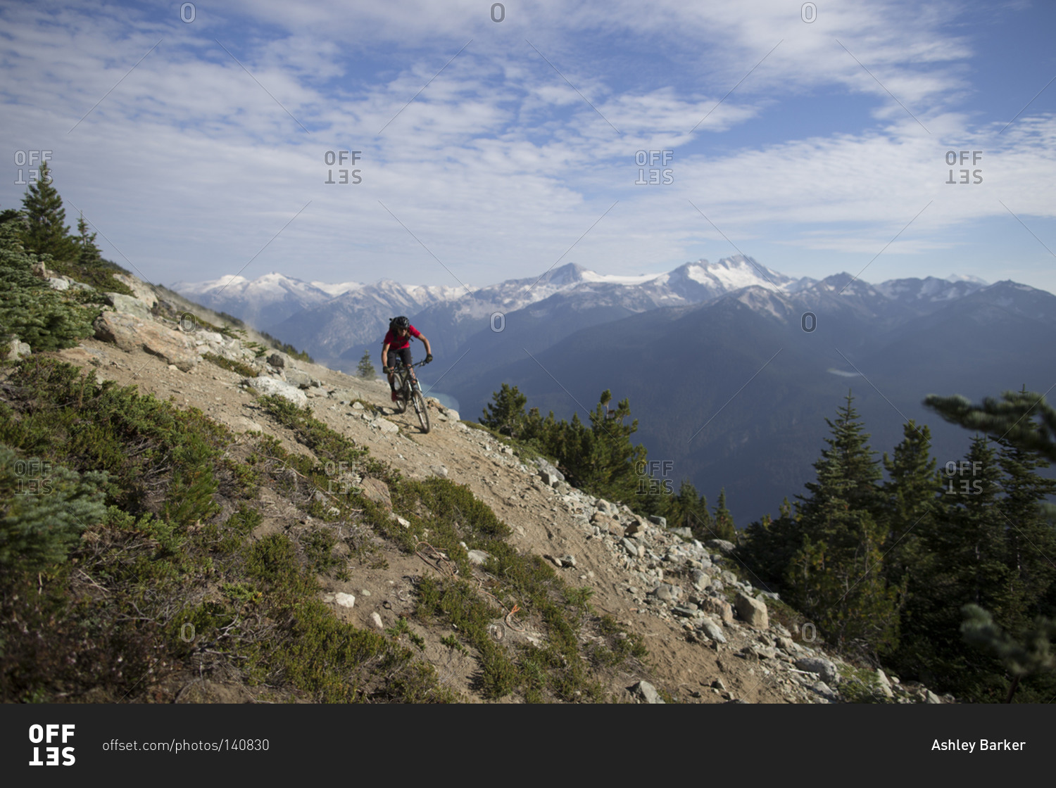 A biker rides down a trail in the Whistler Mountain