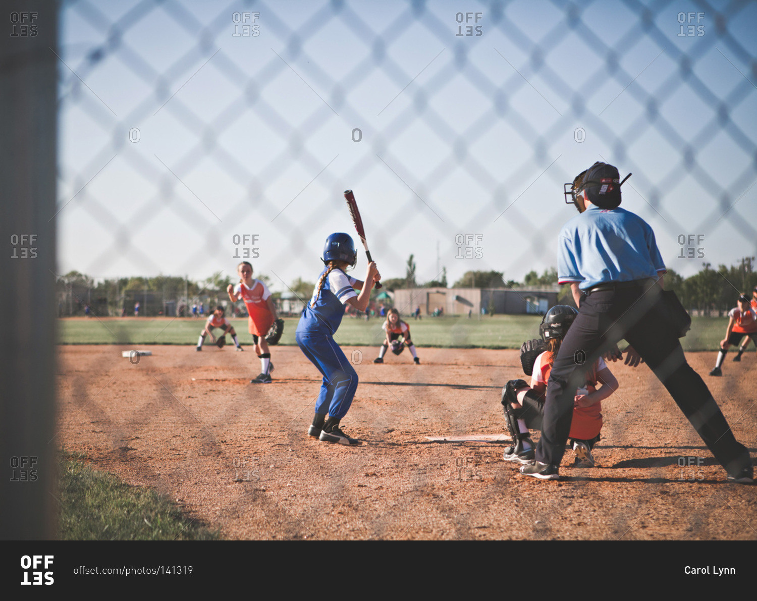 Girls playing baseball in a field