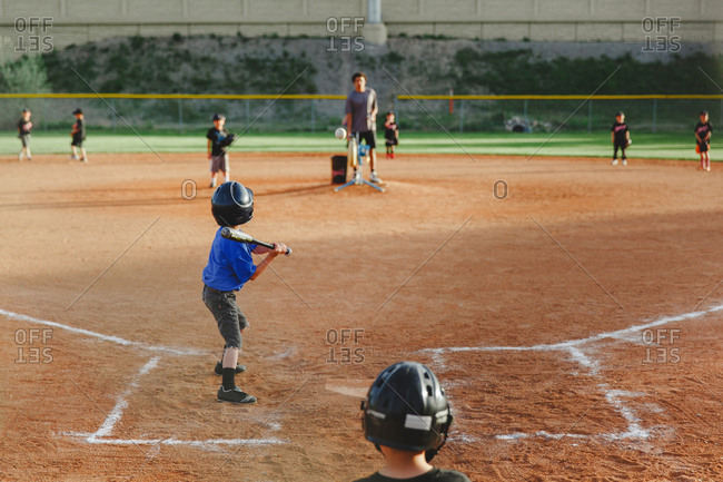 Young boys playing baseball stock photo - OFFSET