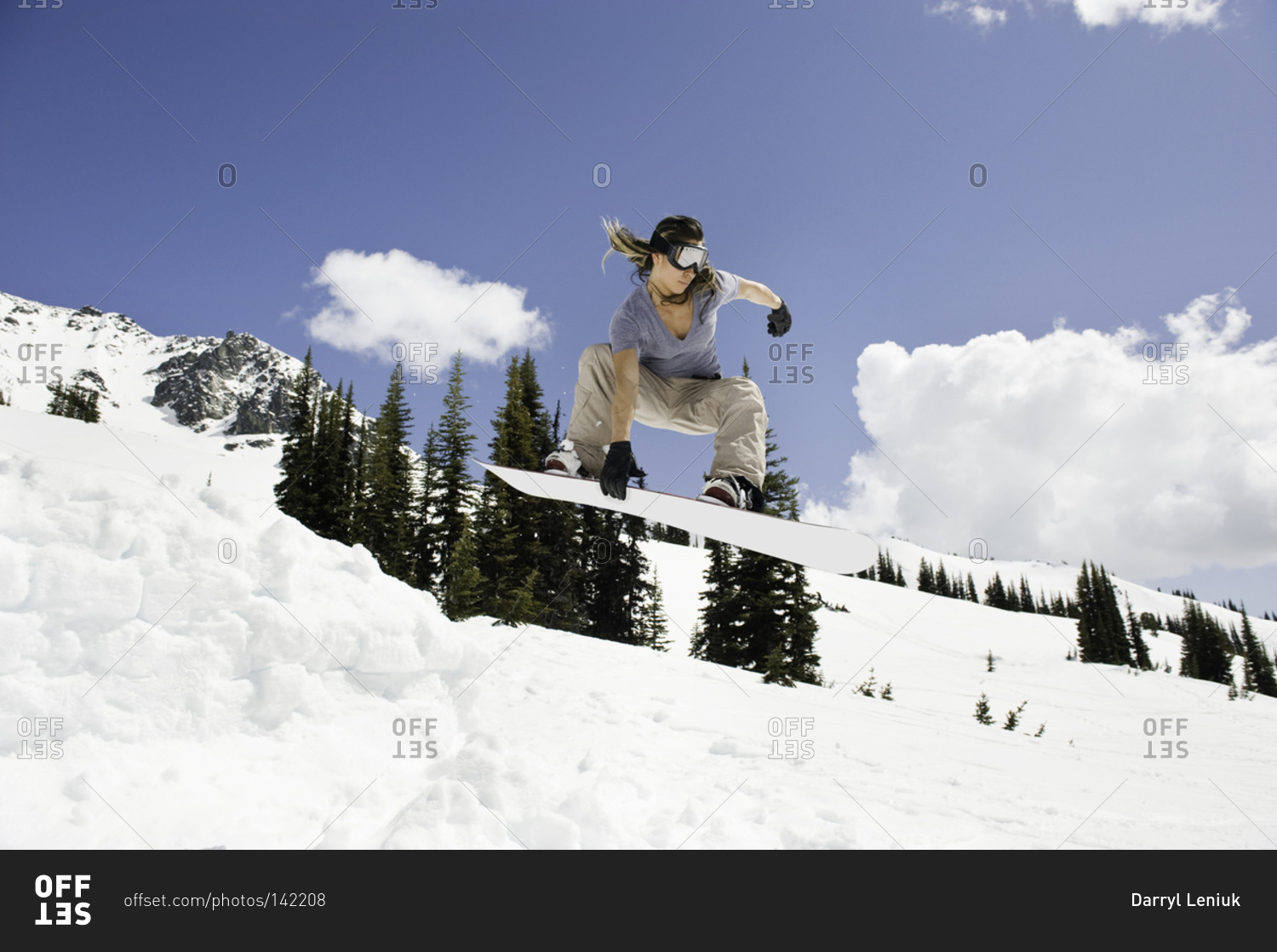 Woman snowboarding on a mountainside