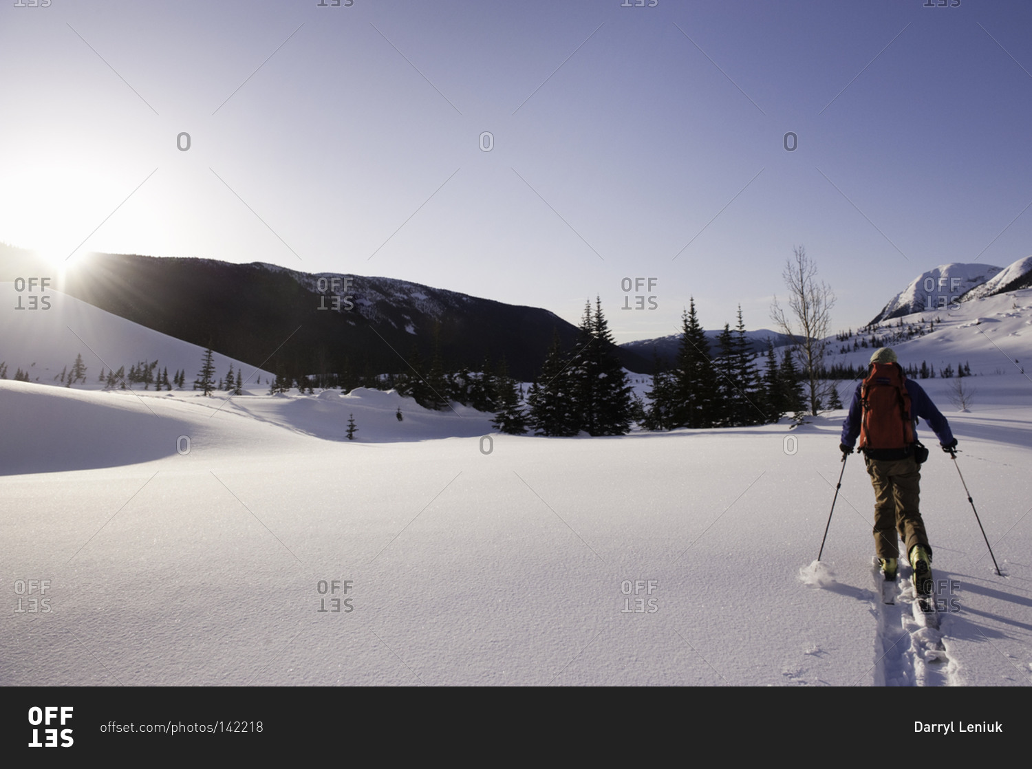A man cross-country skiing on a sunny day