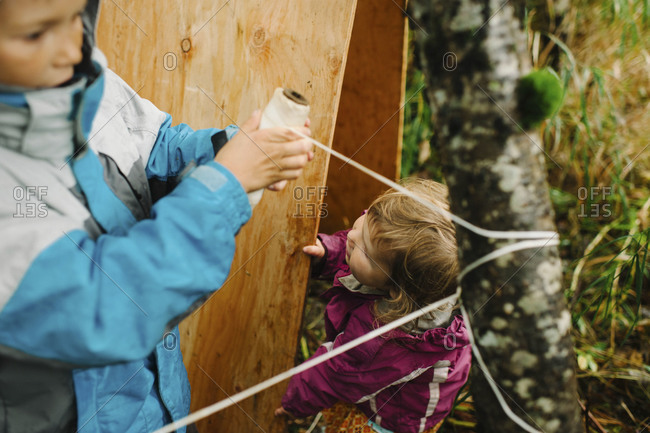 Children building a hut in a forest