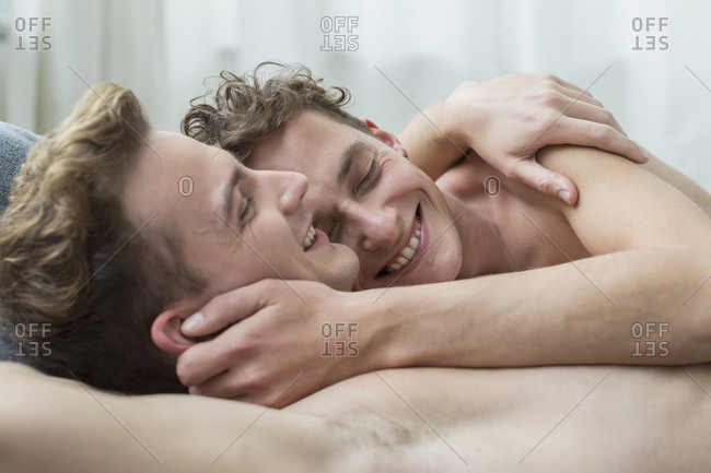 Homosexual couple hugging each other, smiling