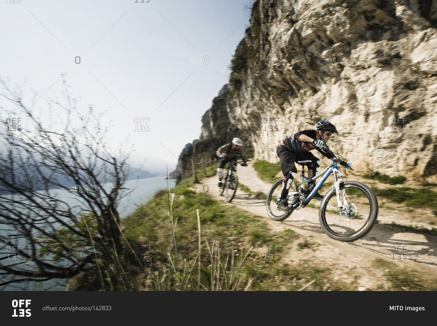 Men riding mountain bike at Lake Garda, Italy
