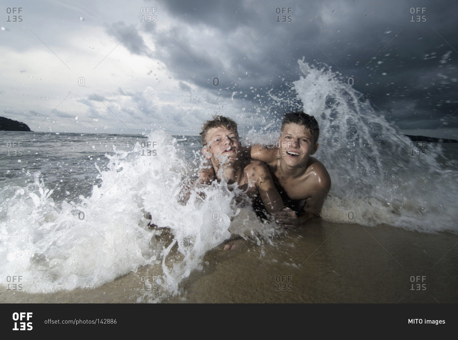 Two boys having fun in ocean, Lankawi, Malaysia