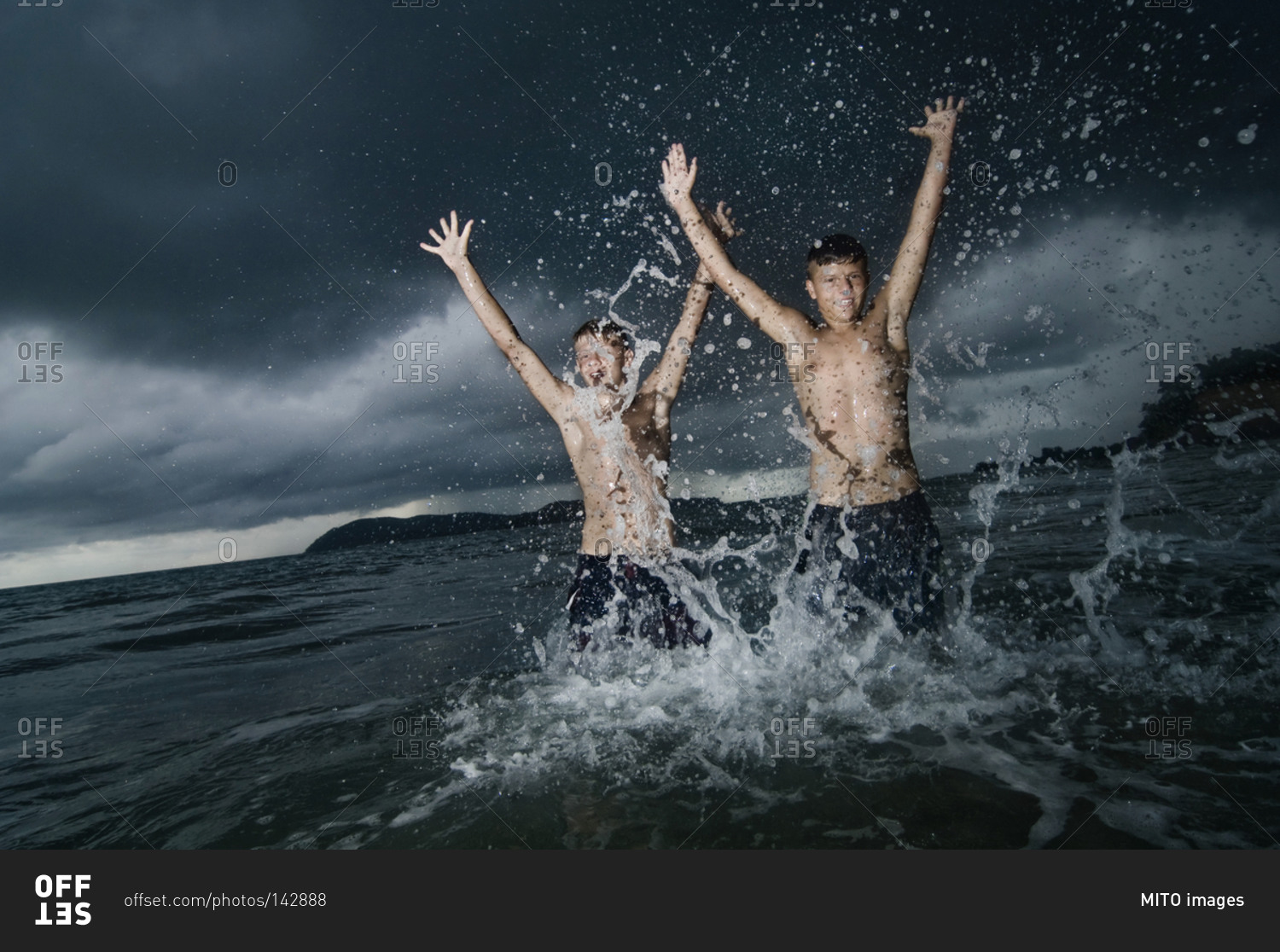 Two boys having fun in ocean, Lankawi, Malaysia