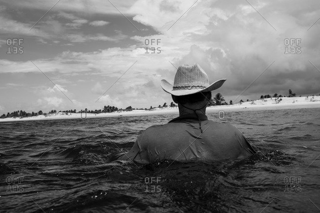 man from the back walking across the water