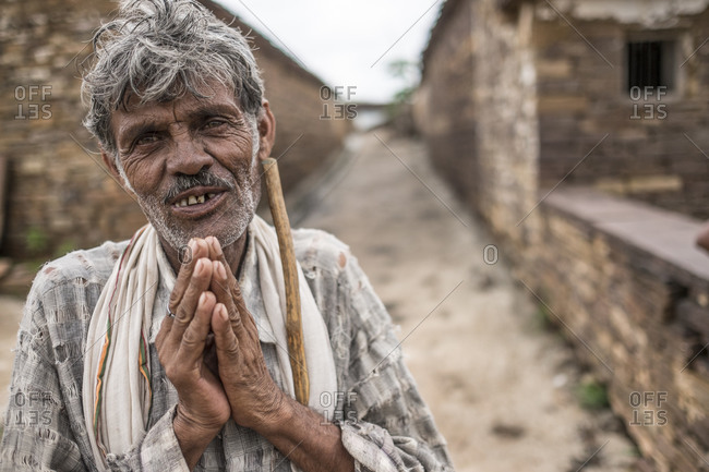 India - August 1, 2014: Man welcomes guest with namaste in a village