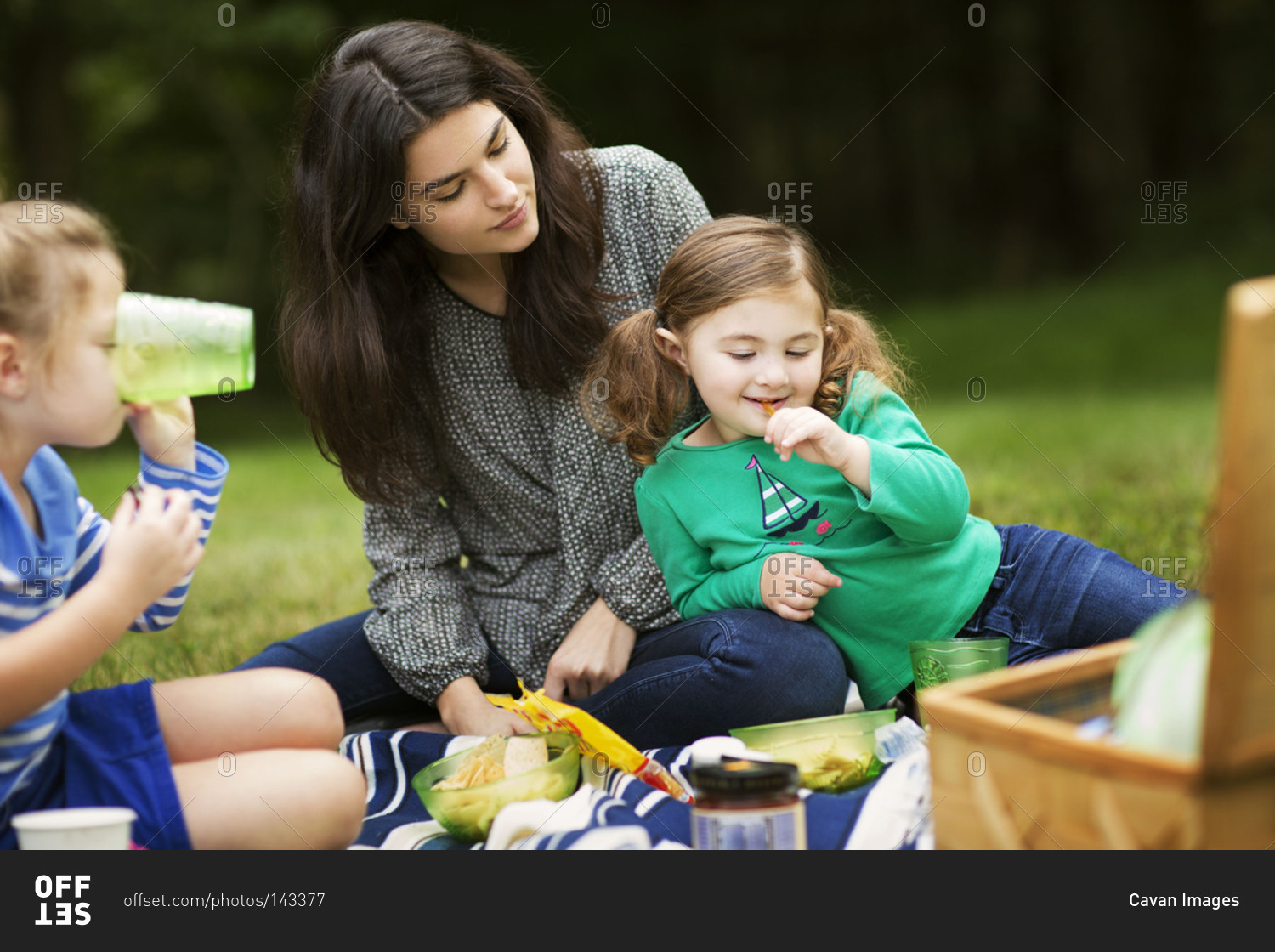Mother and daughters having a picnic