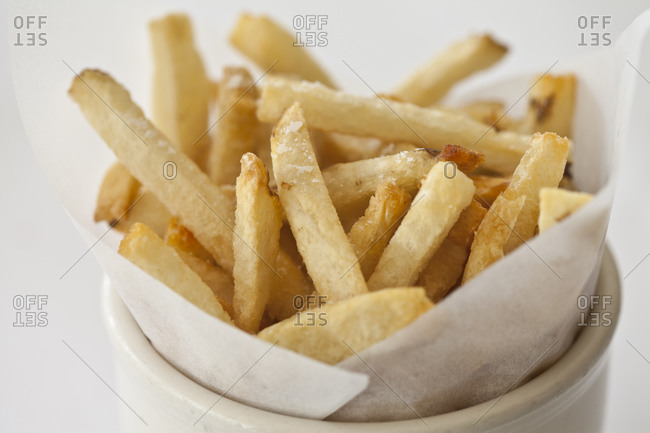 A side of french fries stands in a cup