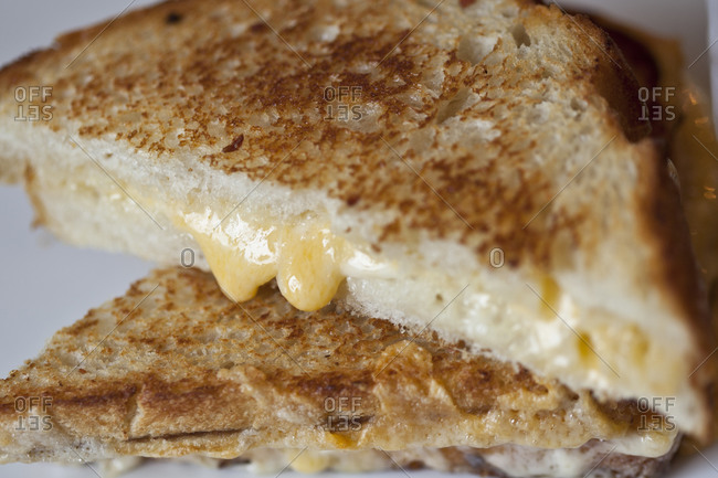 Cheese melts out of a grilled cheese sandwich