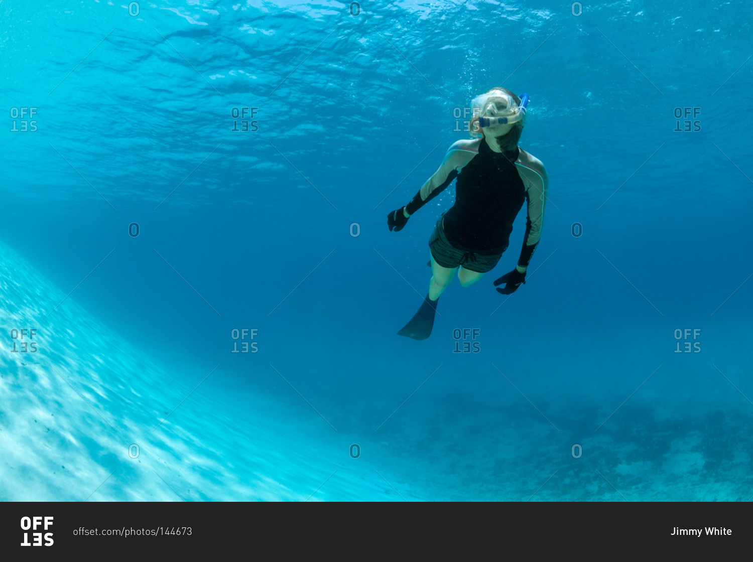 Woman snorkeling near ocean drop off