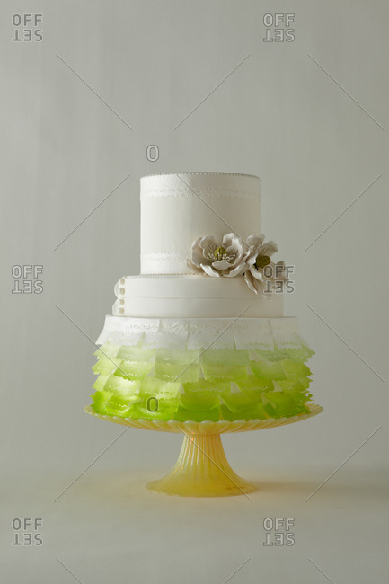 Green ombre flags decorate a three-tiered cake