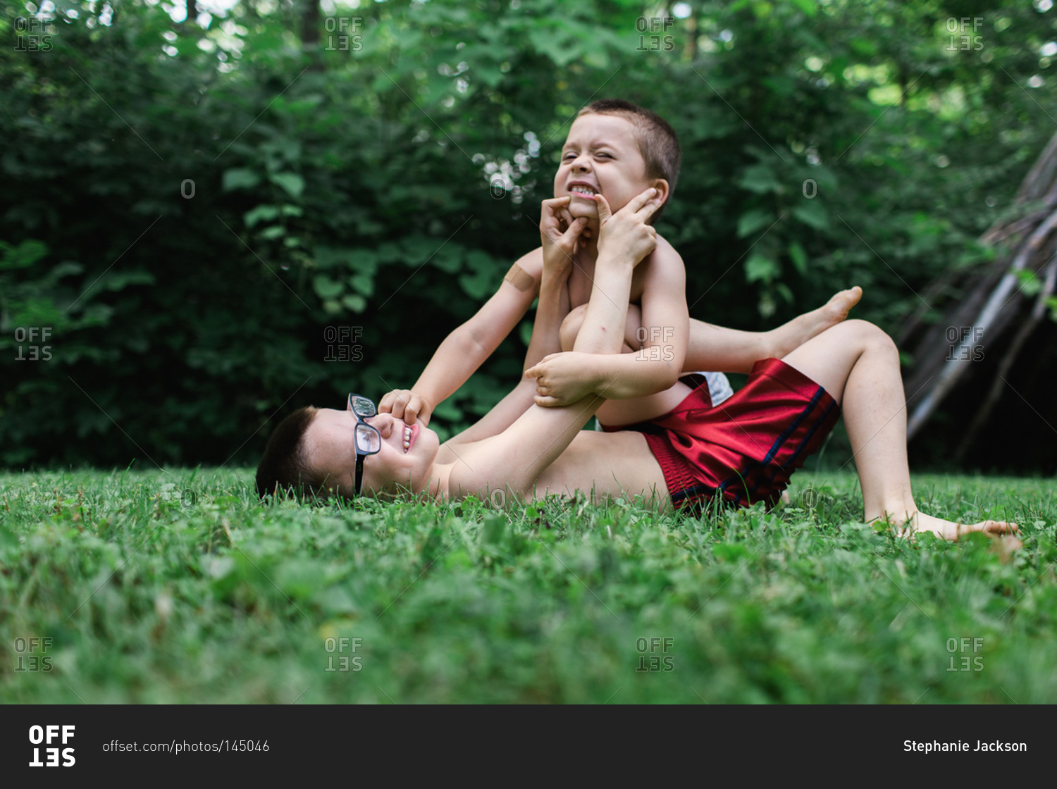 Brothers wrestling in the grass