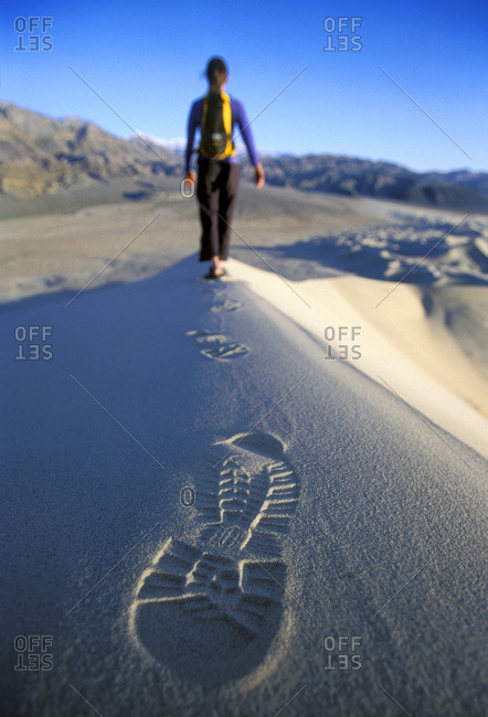 Woman hiking on sand dunes of Death Valley, California