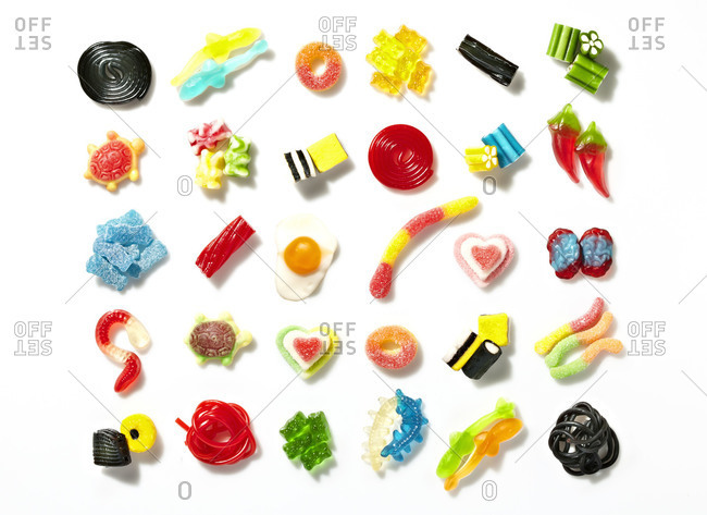 Candy lined up in rows on a white background