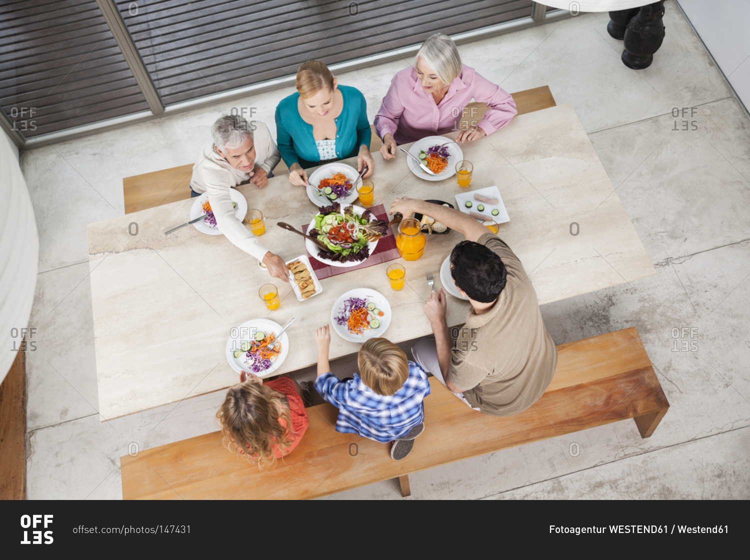 Extended family with salad and juice at dining table
